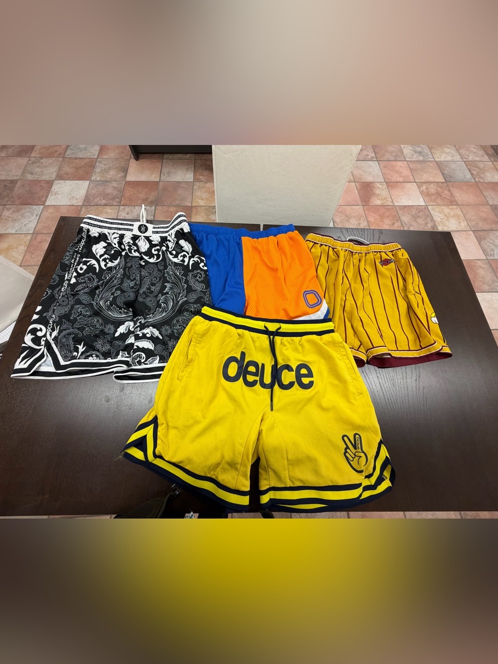 Four pairs of size medium basketball shorts